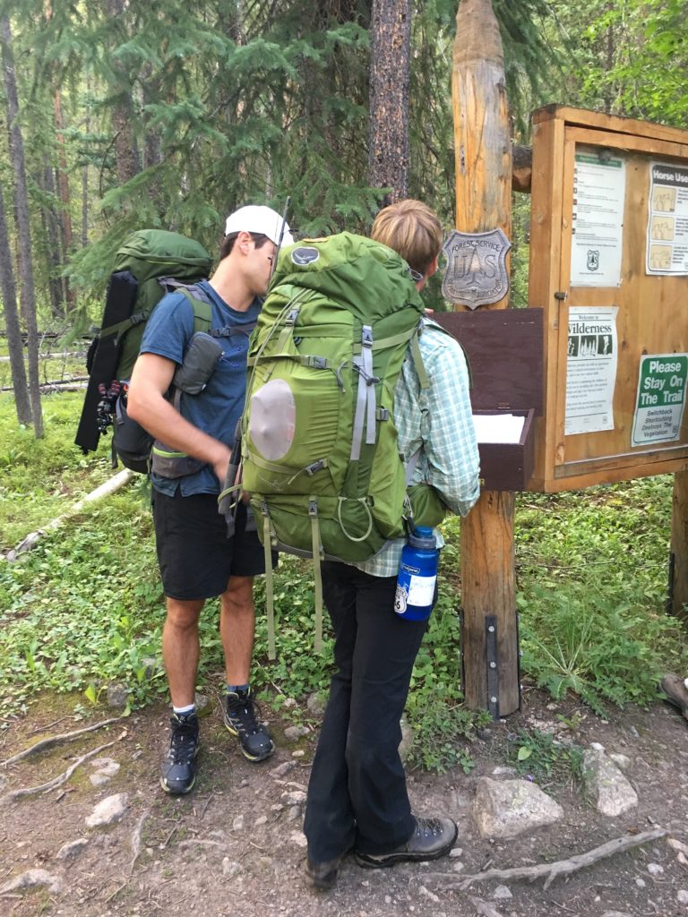 Backpackers with their hydration gear beginning a hike.