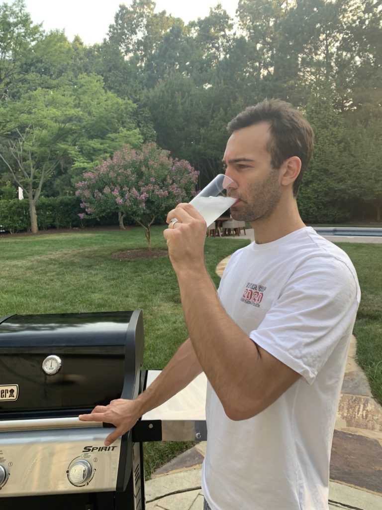 Reviewer drinking Liquid IV while grilling.